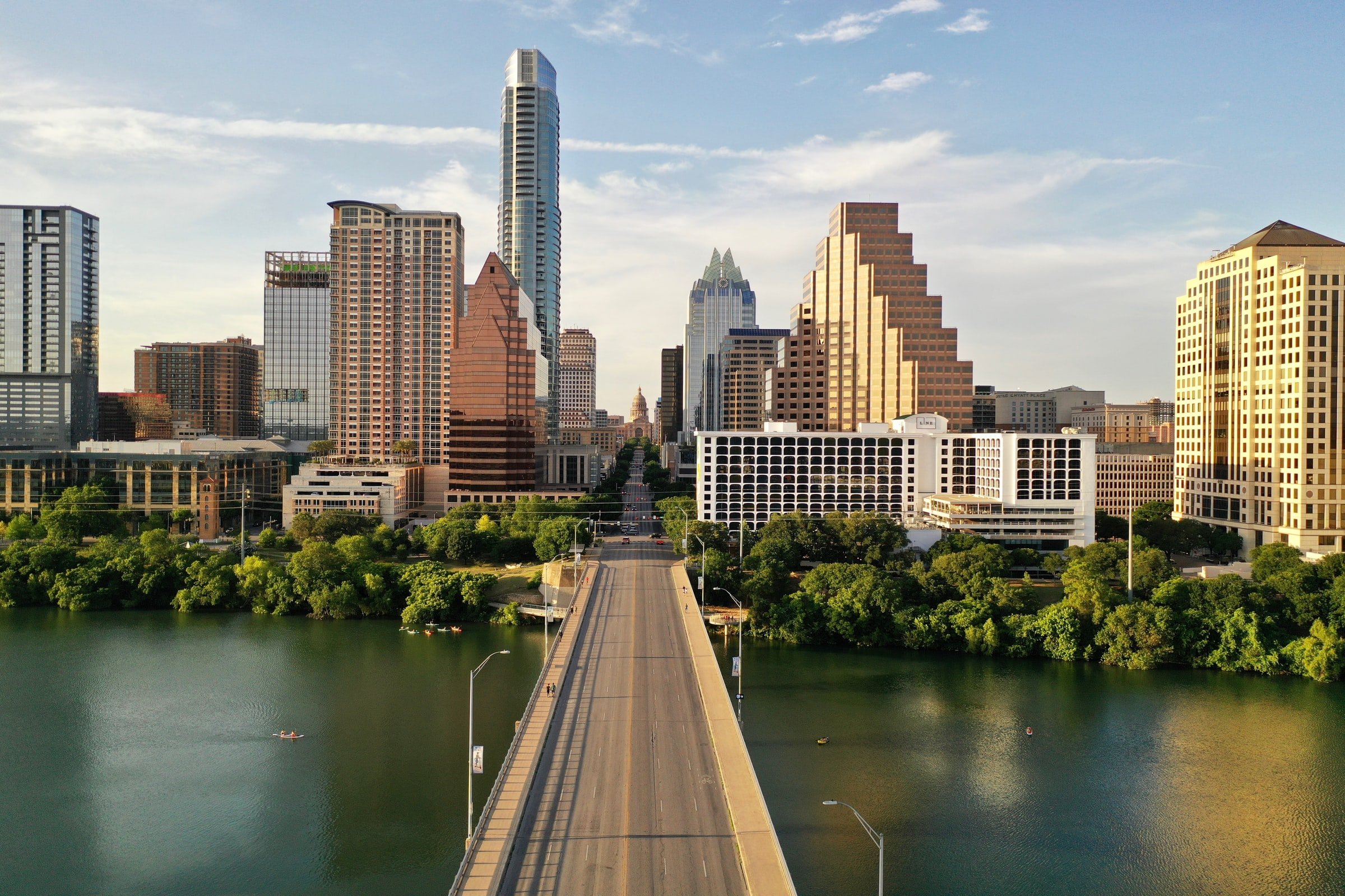 Austin, Texas' city skyline from across a bridge. The Austin skyline seen across Lady Bird Lake from the Congress Avenue bridge