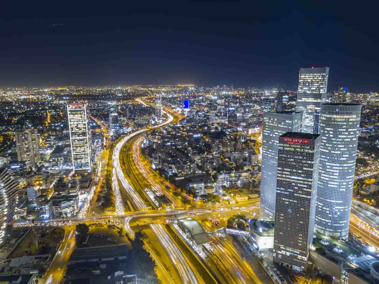 Aerial night view of the Tel Aviv skyline and highway interchange