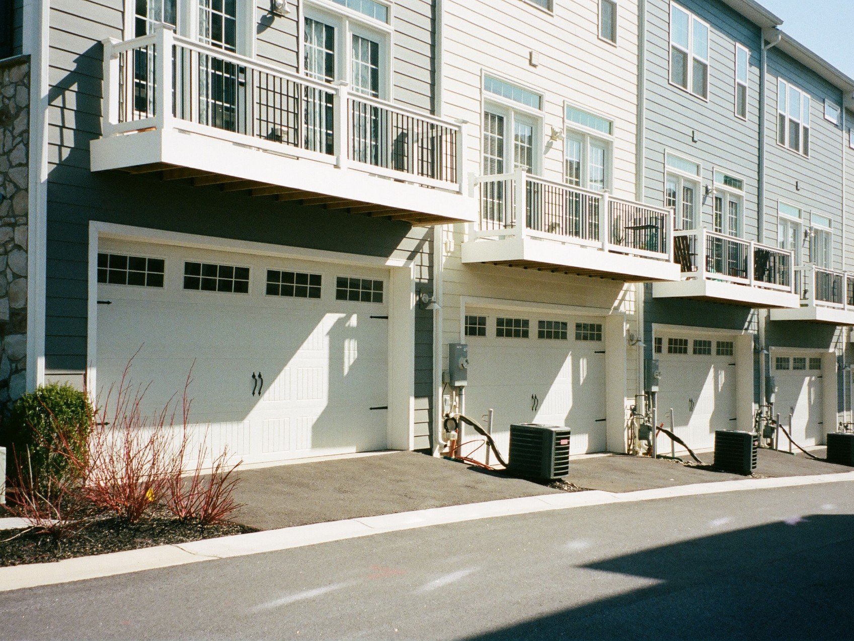 A row of build-to-rent townhomes with attached garages