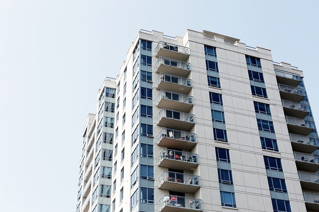 A high-rise apartment tower with stacked balconies