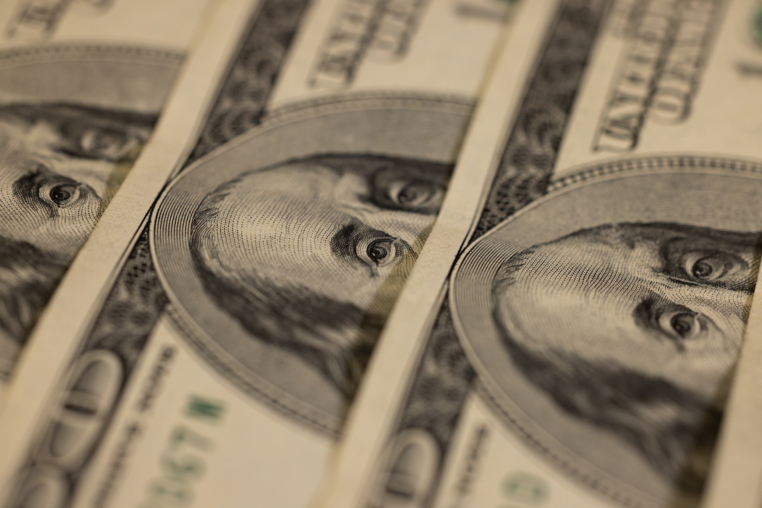 Close-up of overlapping U.S. hundred-dollar bills