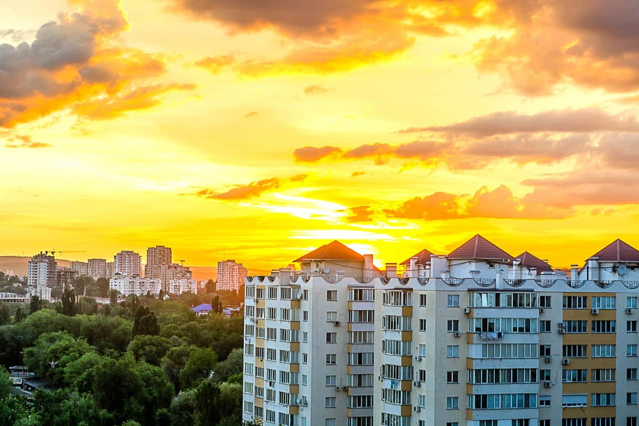 Apartment buildings on a city skyline at sunset
