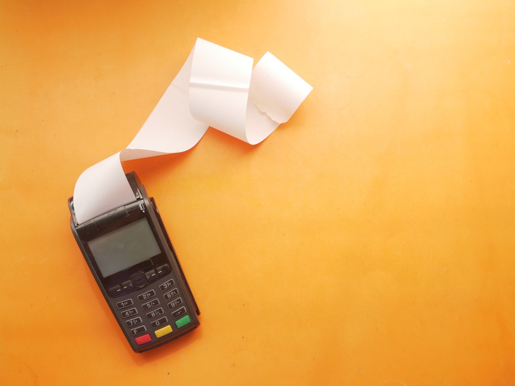 (Image) A card terminal printing a long receipt