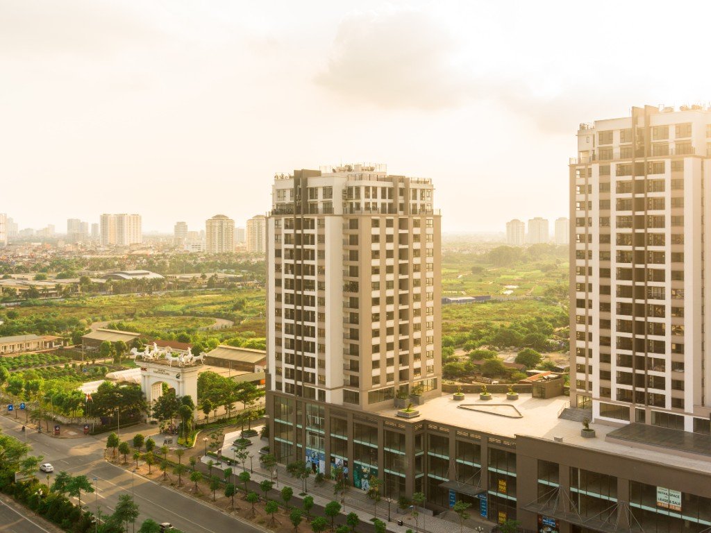 Two newly built apartment towers overlooking a growing metro area